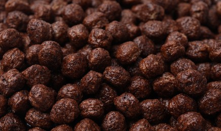 Tasty chocolate cereal balls as background, closeup