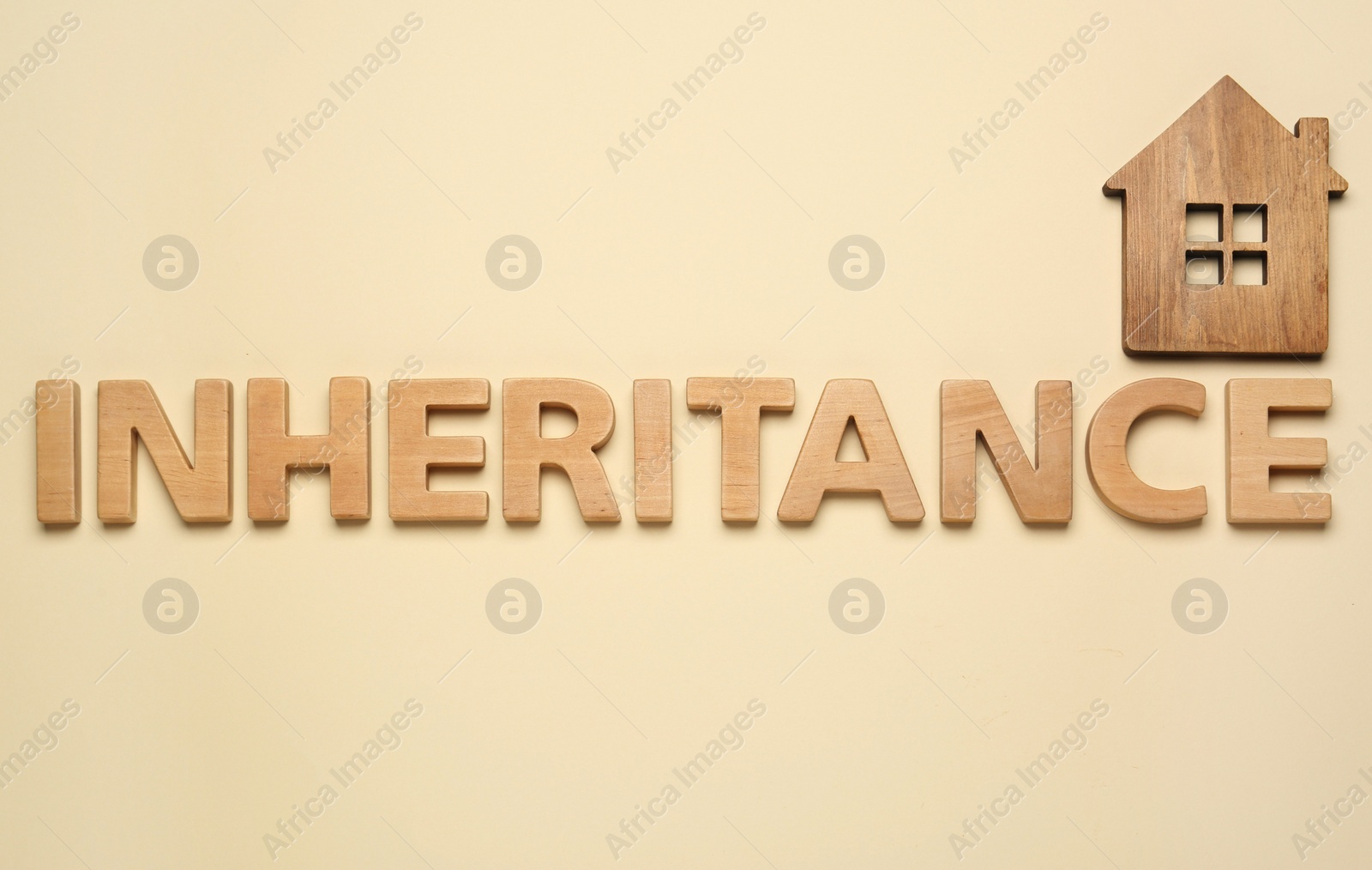 Photo of Word Inheritance made with wooden letters and house model on beige background, flat lay