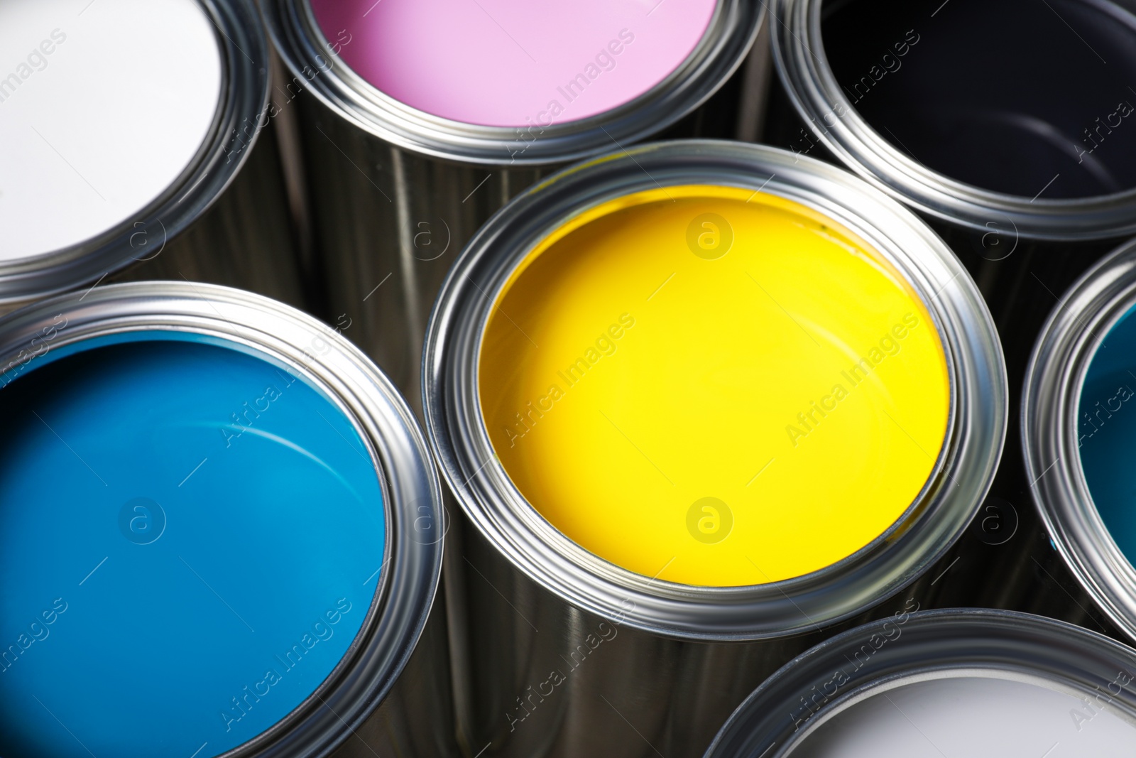 Photo of Open cans of different paints as background, closeup