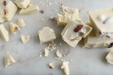 Pieces of white chocolate with nuts on light table