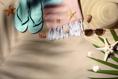 Photo of Flat lay composition with beach objects on sand. Space for text