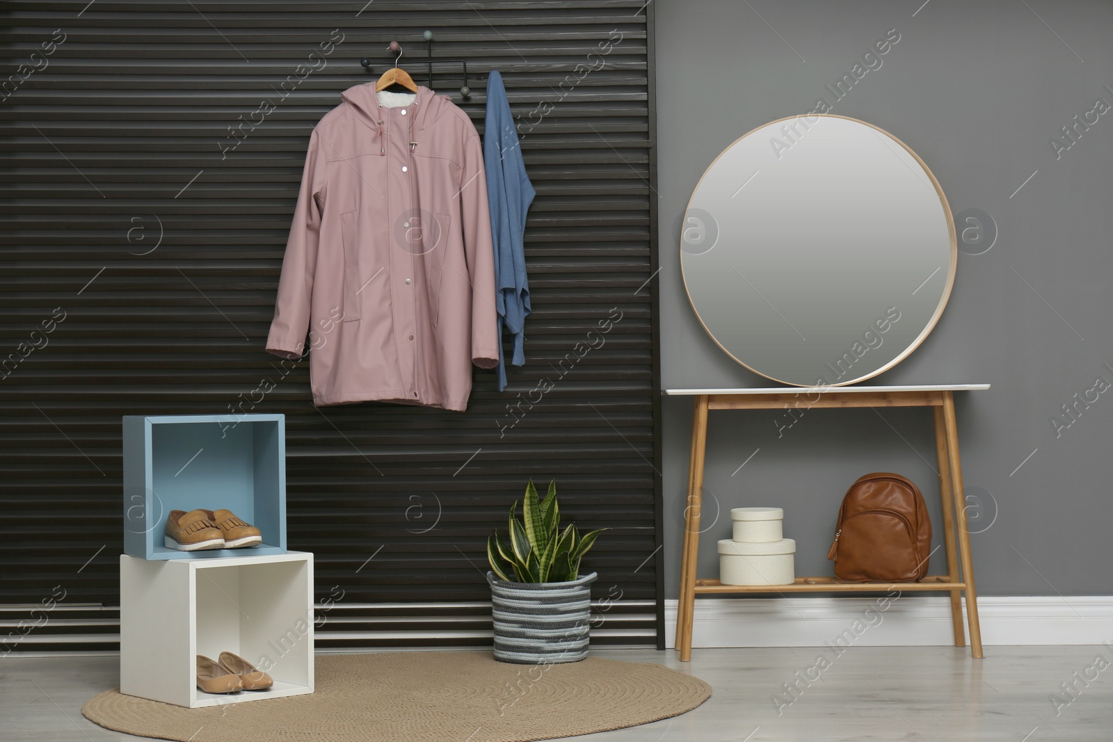 Photo of Hallway interior with stylish furniture, clothes and accessories