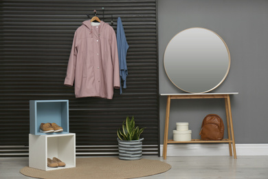 Hallway interior with stylish furniture, clothes and accessories