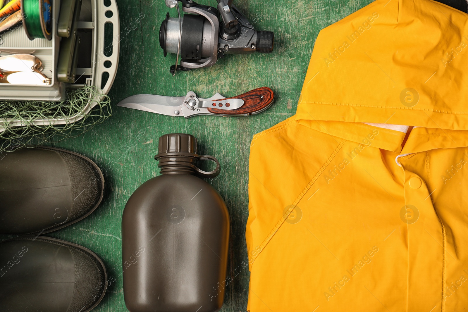 Photo of Flat lay composition with fishing equipment on wooden background