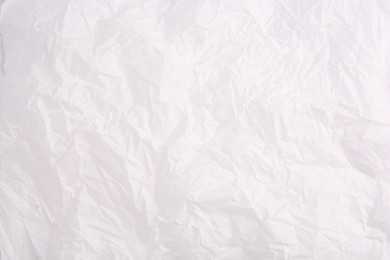 Photo of Texture of crumpled parchment paper as background, top view