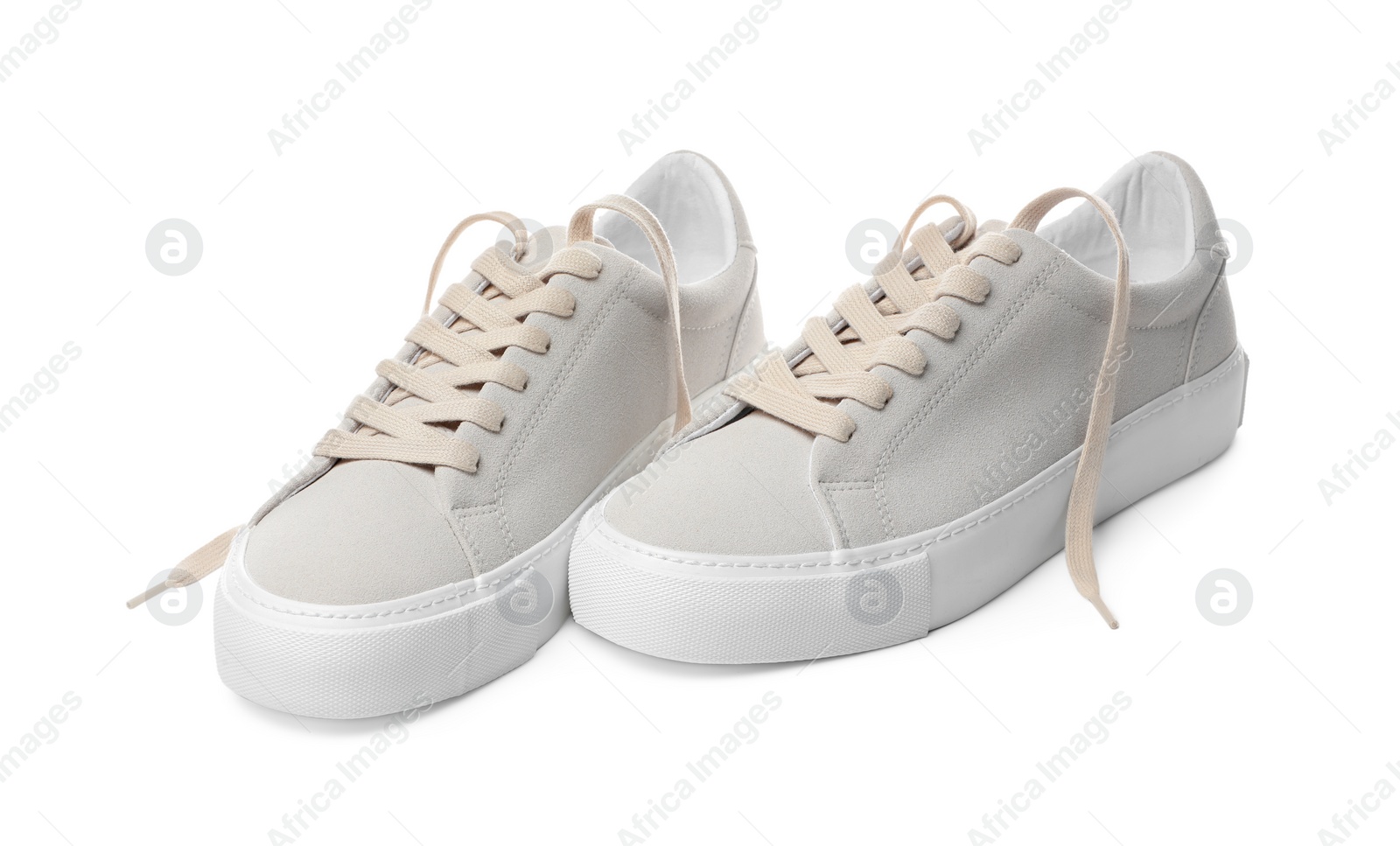 Photo of Pair of stylish beige sneakers isolated on white