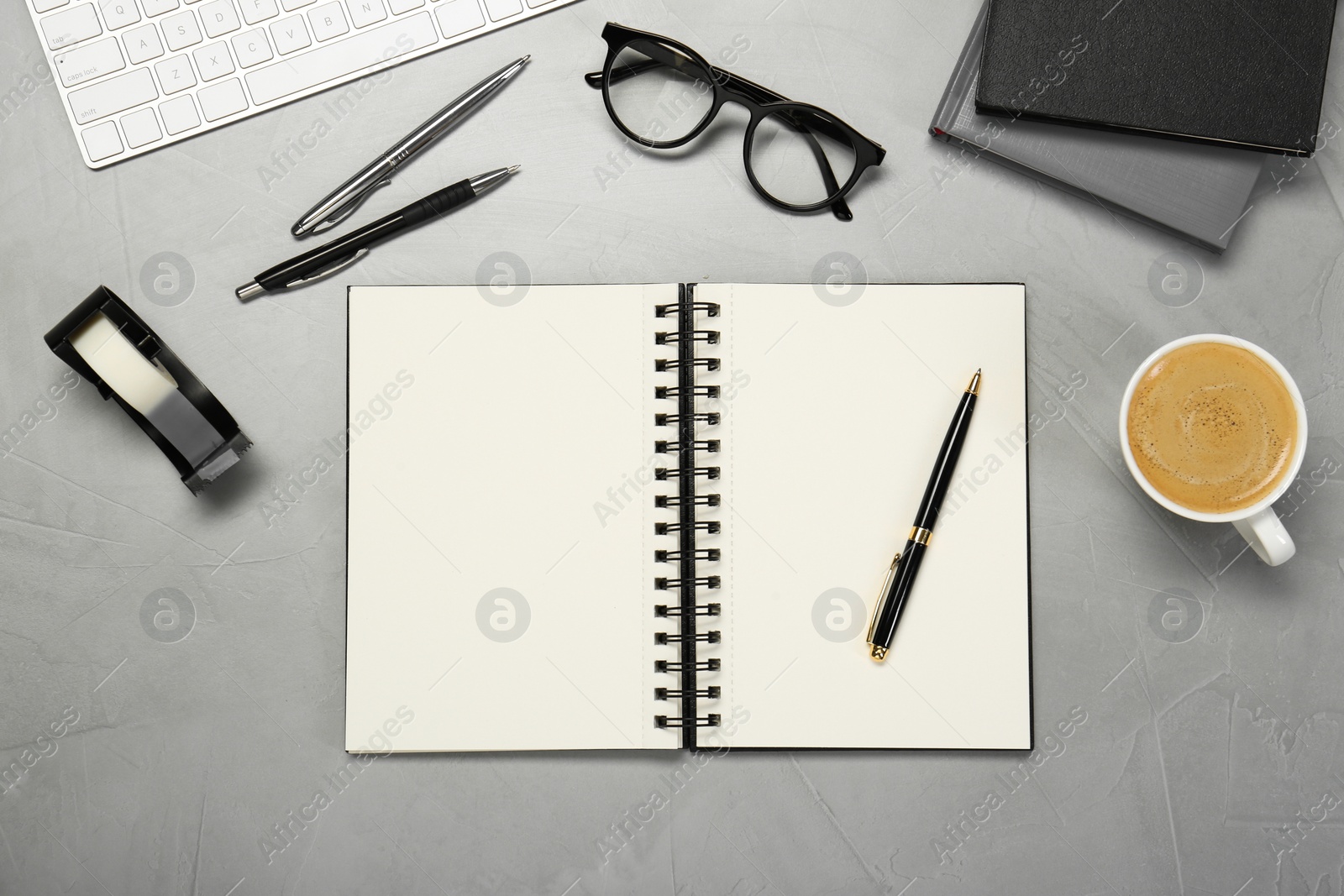 Photo of Flat lay composition with notebooks, glasses and coffee on light grey table