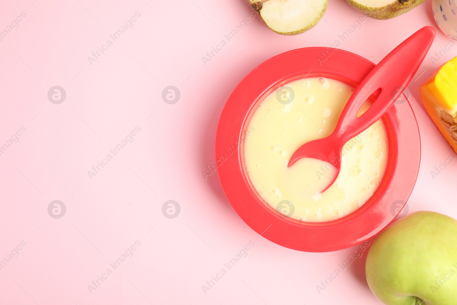 Photo of Baby food in bowl and fresh ingredients on pink background, flat lay. Space for text