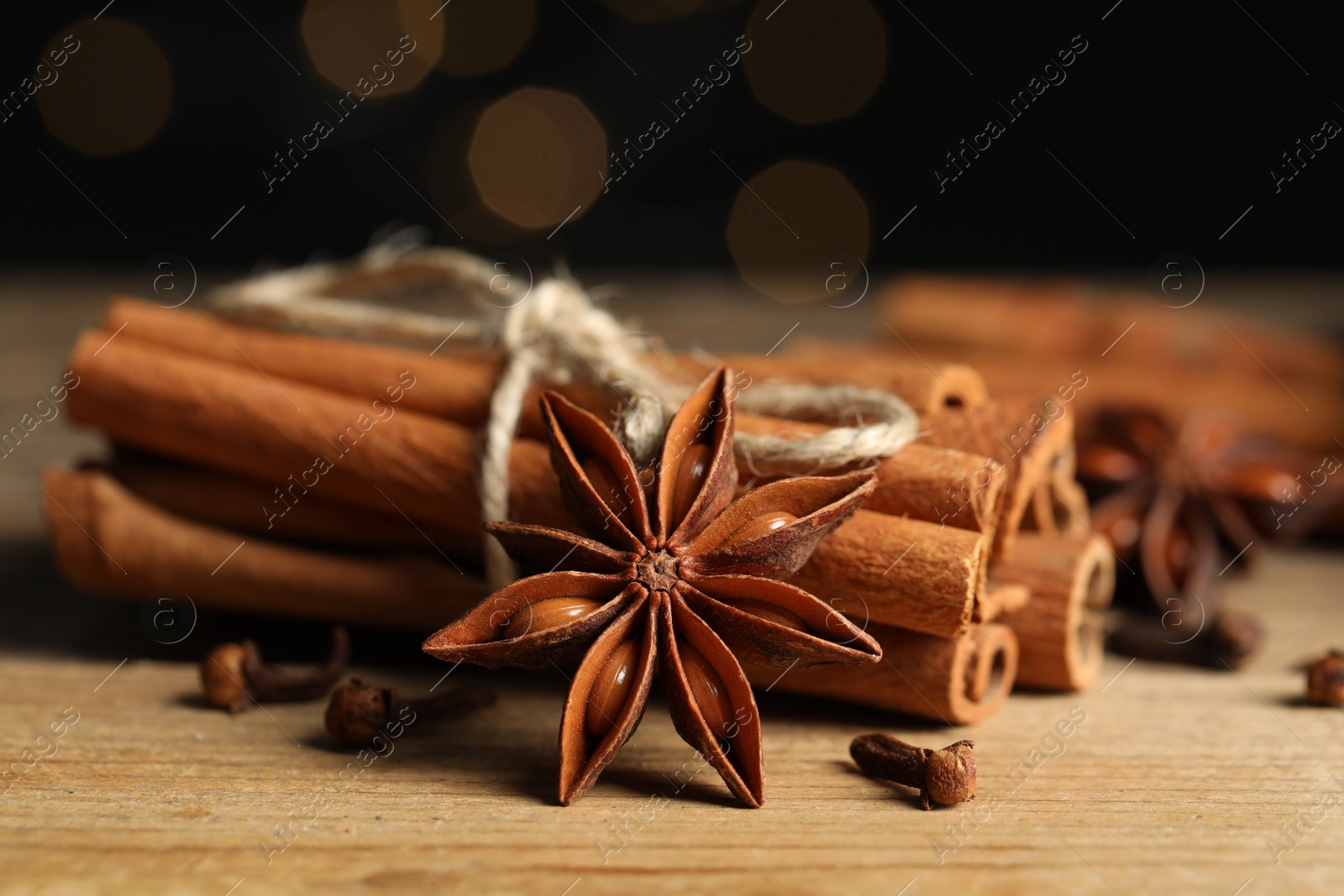 Photo of Different aromatic spices on wooden table, closeup