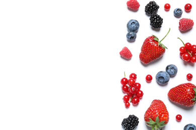 Mix of fresh berries on white background, flat lay