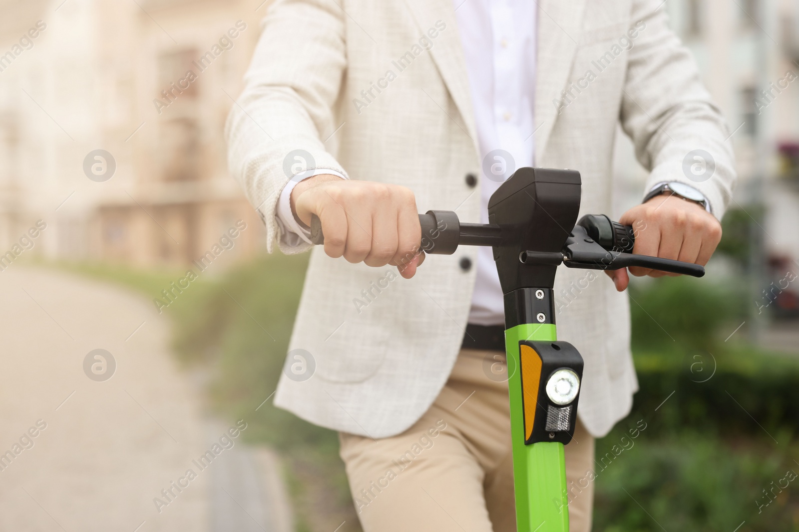 Photo of Businessman with modern kick scooter on city street, closeup. Space for text