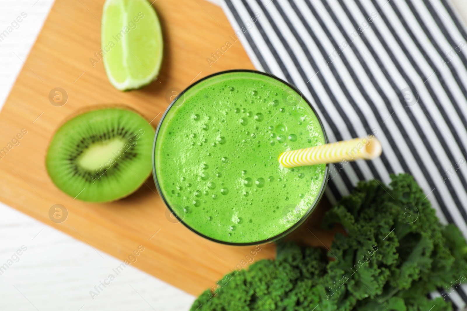 Photo of Tasty fresh kale smoothie on white wooden table