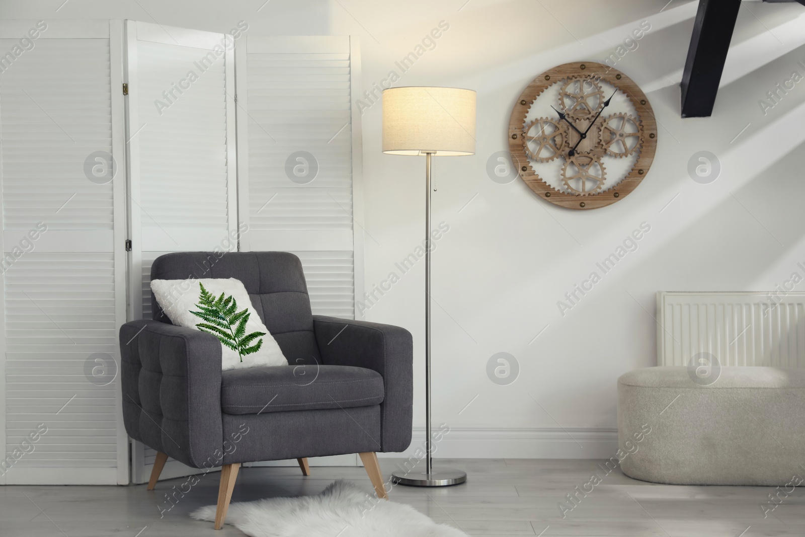 Image of Soft pillow with printed tropical leaf on armchair indoors