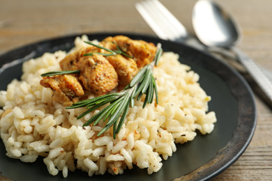 Photo of Delicious risotto with chicken on plate, closeup