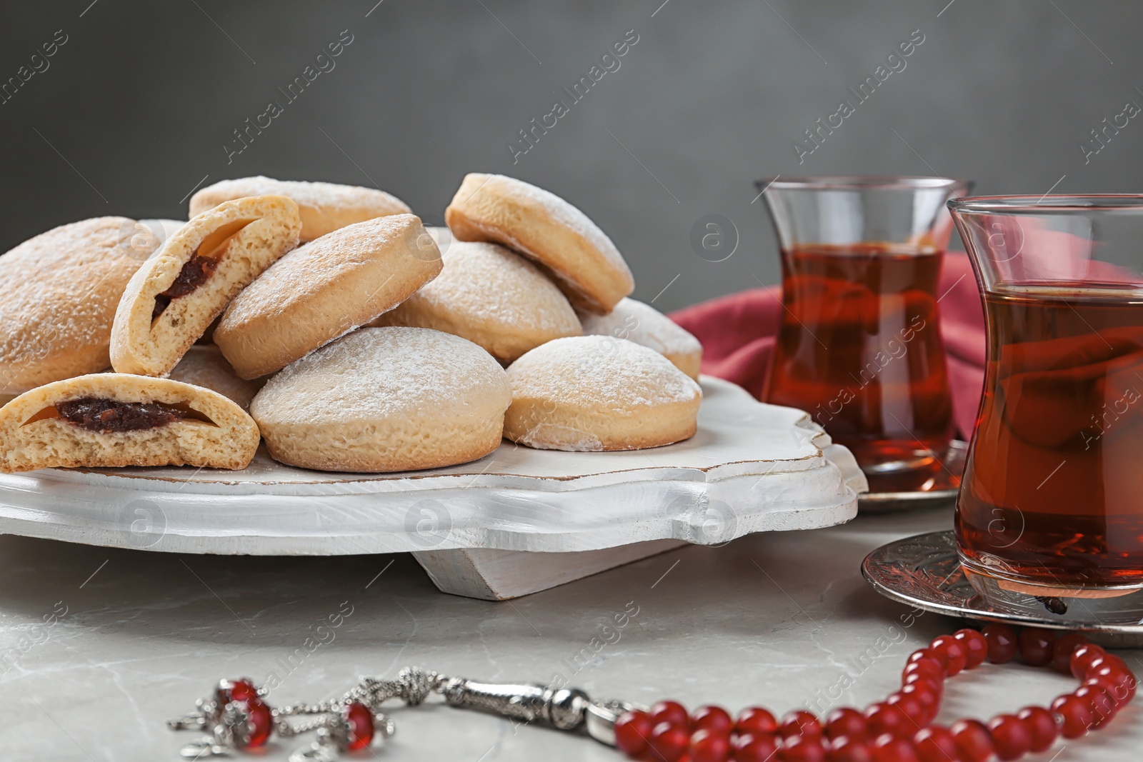 Photo of Traditional cookies for Islamic holidays and tea on table. Eid Mubarak