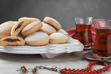 Photo of Traditional cookies for Islamic holidays and tea on table. Eid Mubarak