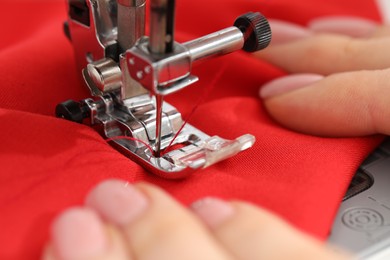 Photo of Seamstress working with sewing machine, selective focus