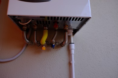 One gas boiler hanging on white wall, closeup