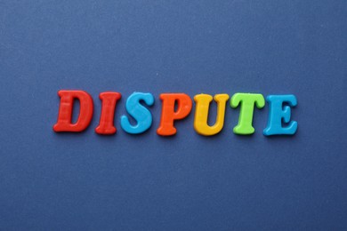 Word Dispute made of colorful letters on blue background, flat lay