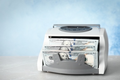 Modern bill counter with money on table