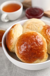 Photo of Tasty scones prepared on soda water on grey marble table, closeup