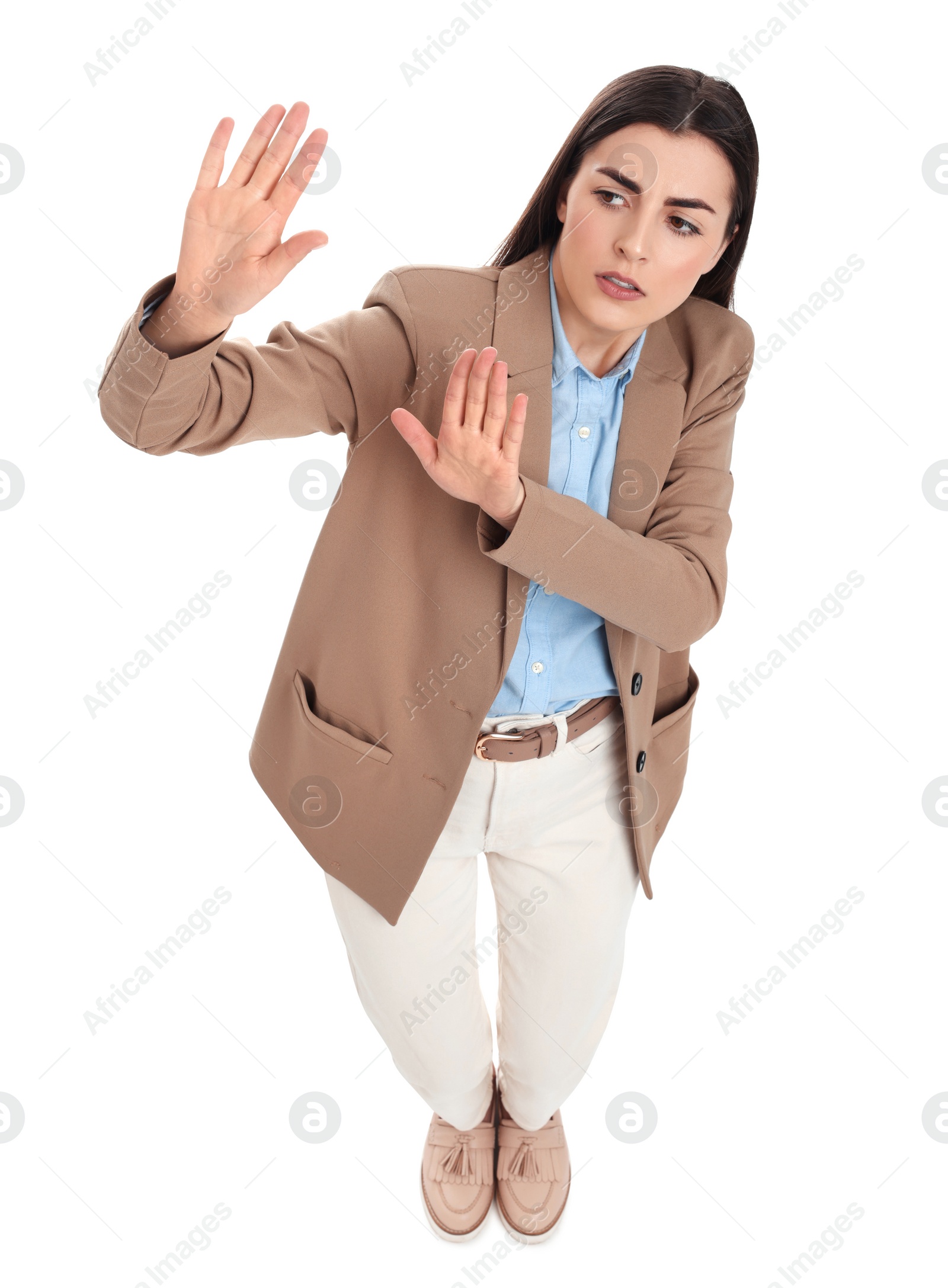 Photo of Beautiful businesswoman avoiding something on white background, above view