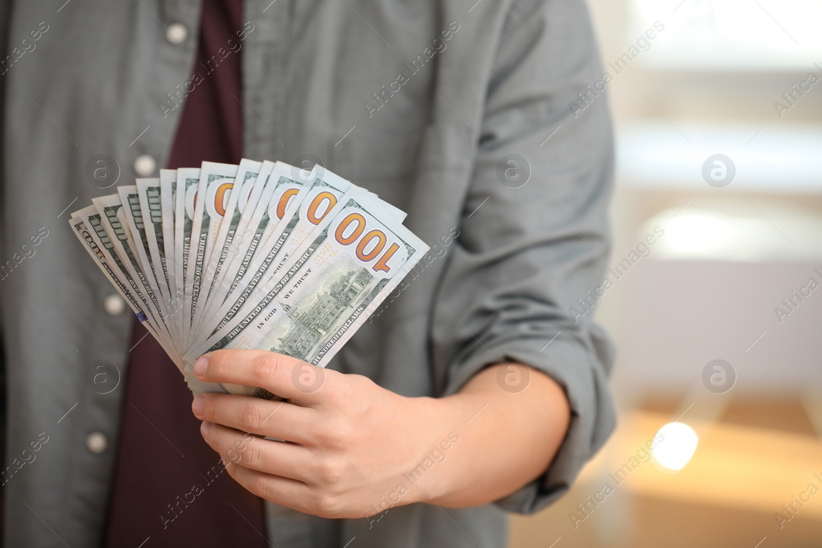 Photo of Man with American money on blurred background, closeup