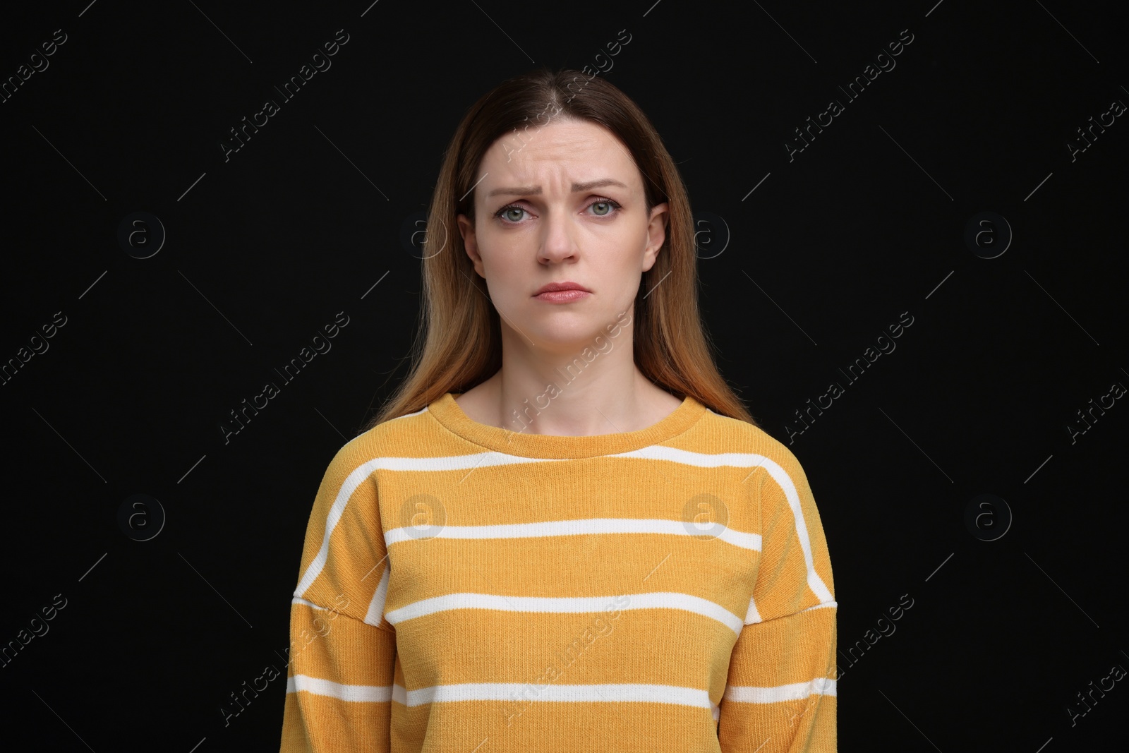 Photo of Portrait of sad woman on black background