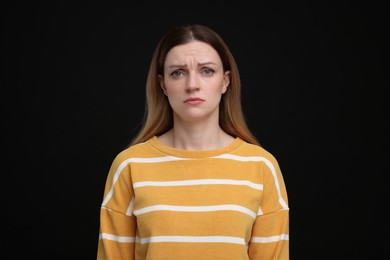 Photo of Portrait of sad woman on black background