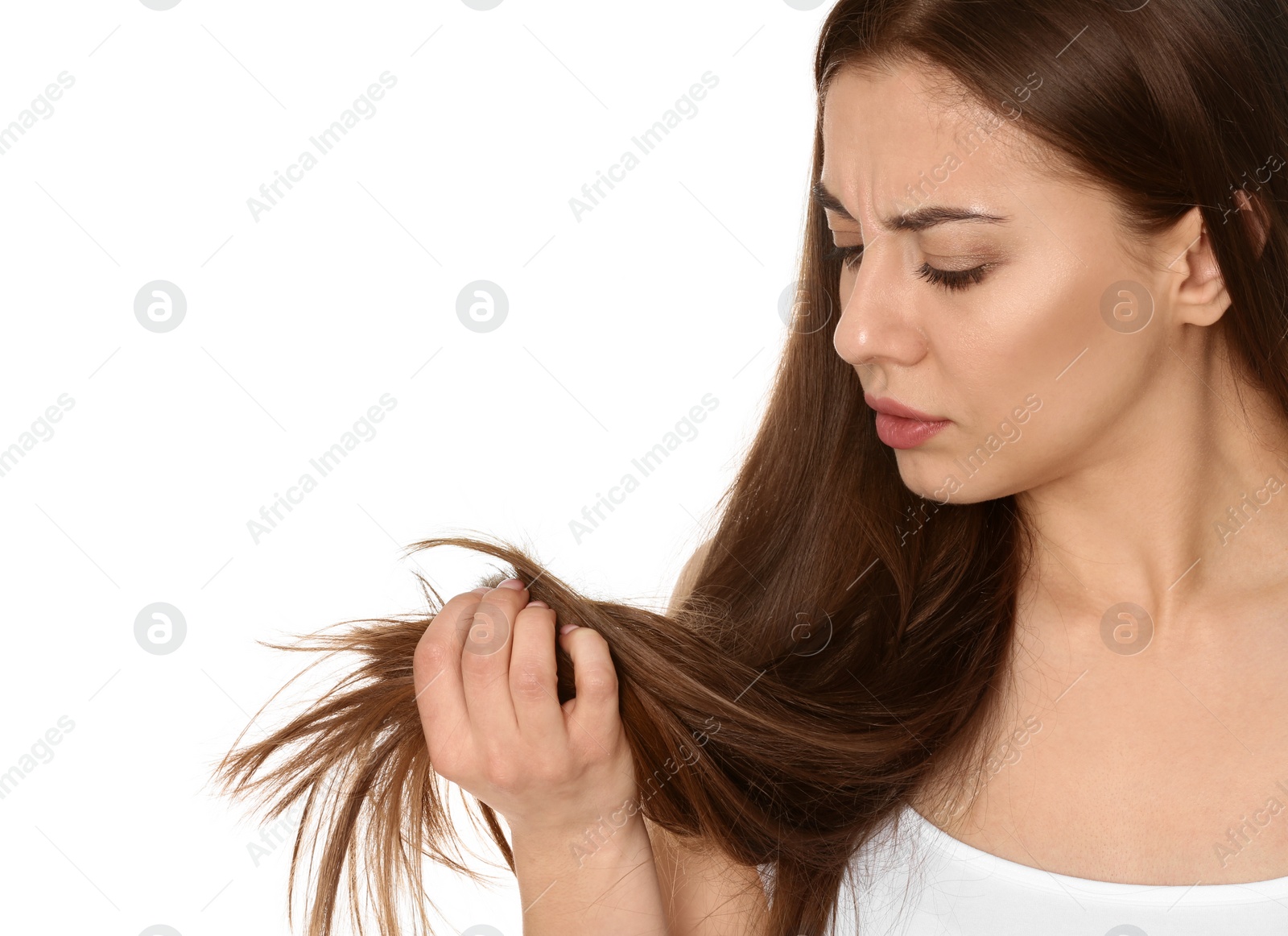 Photo of Emotional woman with damaged hair on white background. Split ends