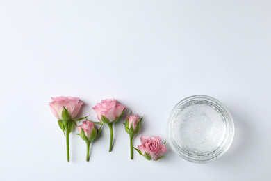 Photo of Composition with cosmetic gel and beautiful flowers on white background, top view