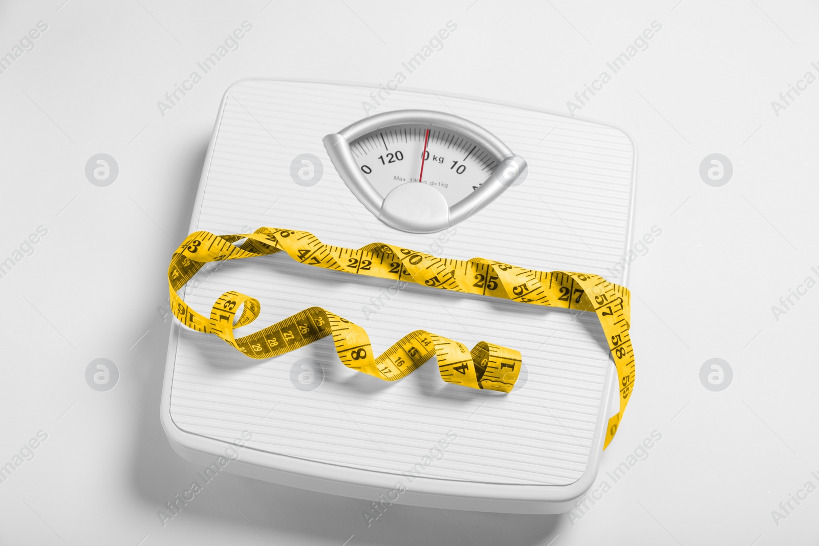 Photo of Weight loss concept. Scales and measuring tape on white background