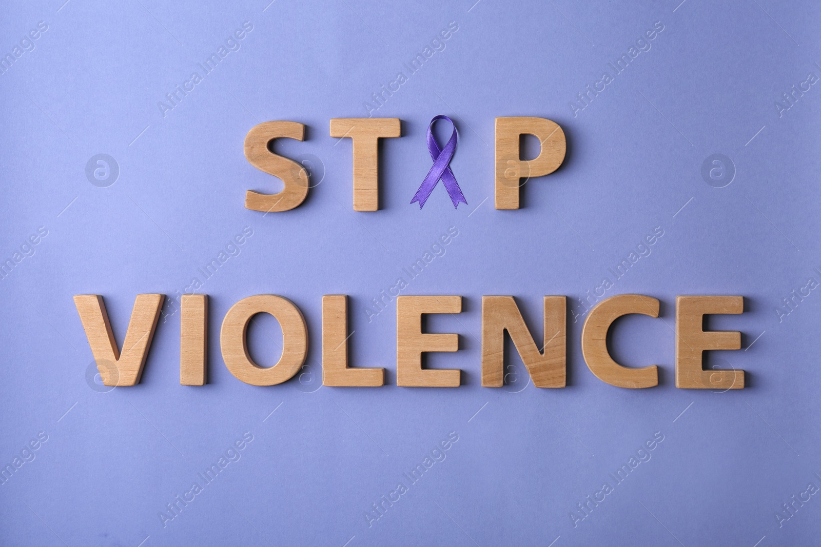 Photo of Flat lay composition with purple ribbon and words STOP VIOLENCE on violet background. Awareness day