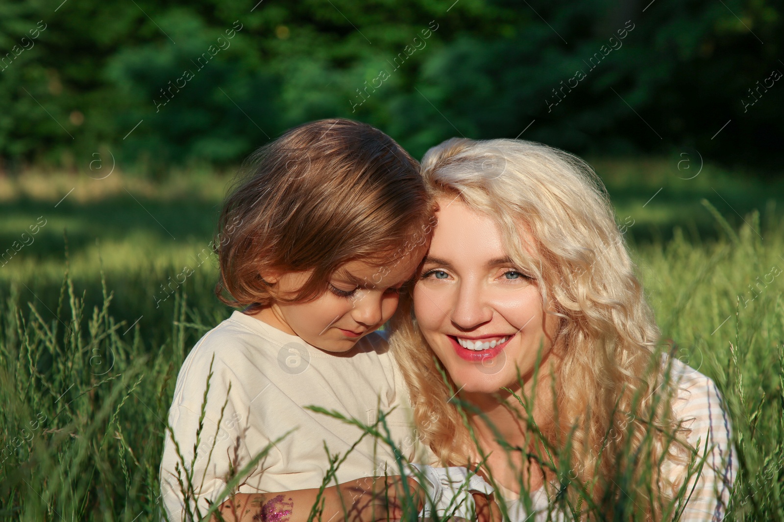 Photo of Happy mother with her cute daughter spending time together outdoors