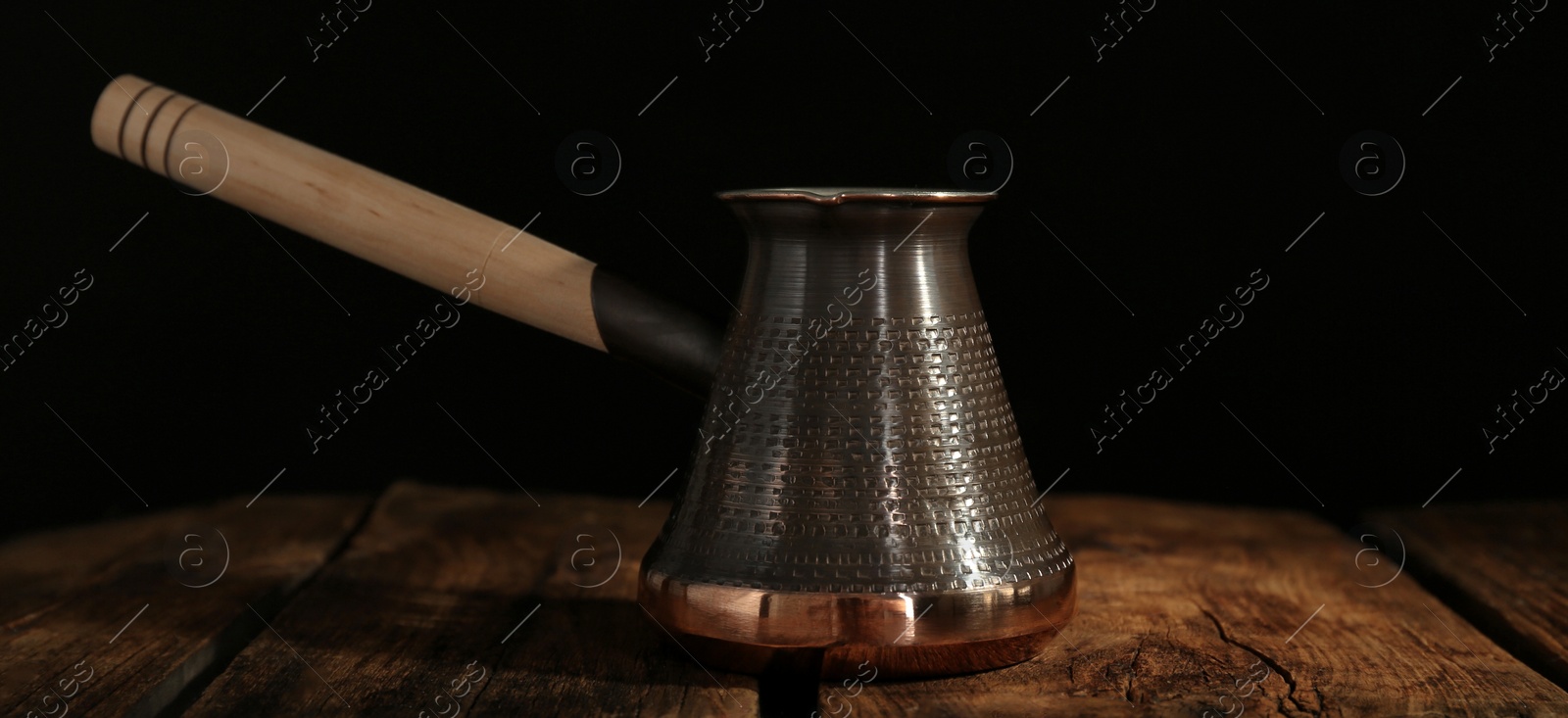 Image of Turkish coffee. Cezve on wooden table. Banner design