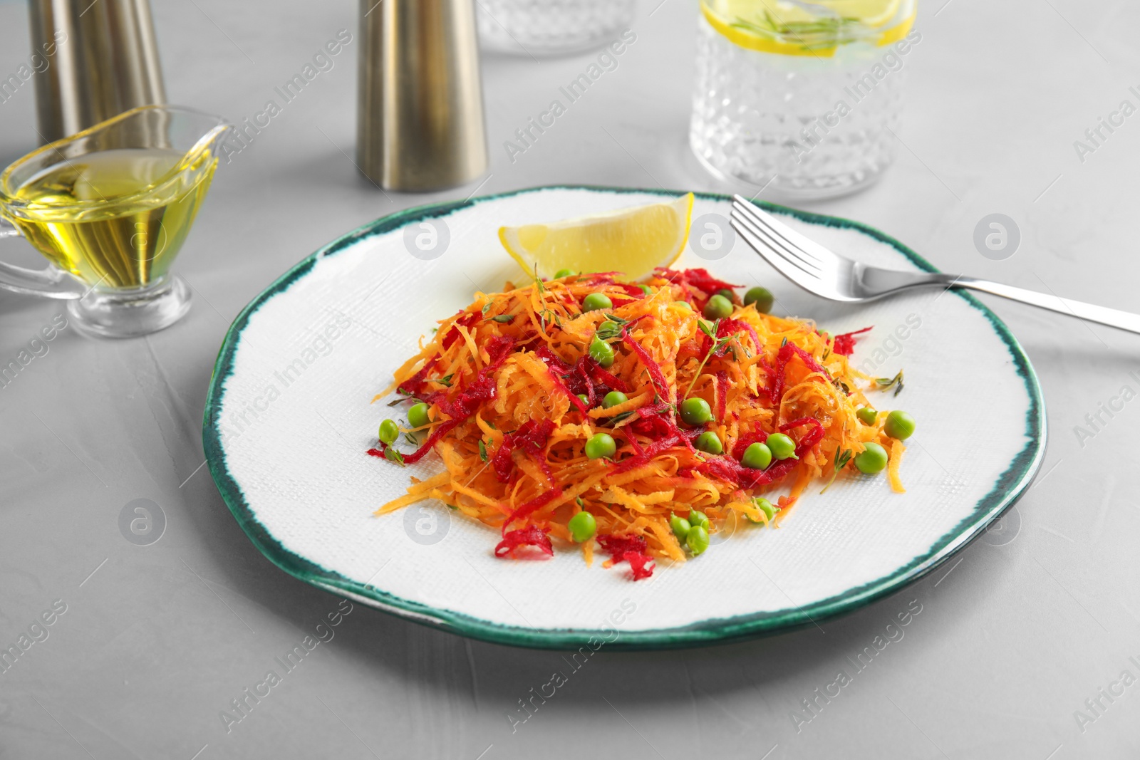 Photo of Tasty salad with fresh carrot on plate