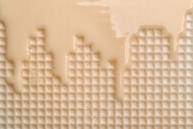 Photo of Hot white chocolate on wafer, closeup. Crispy food