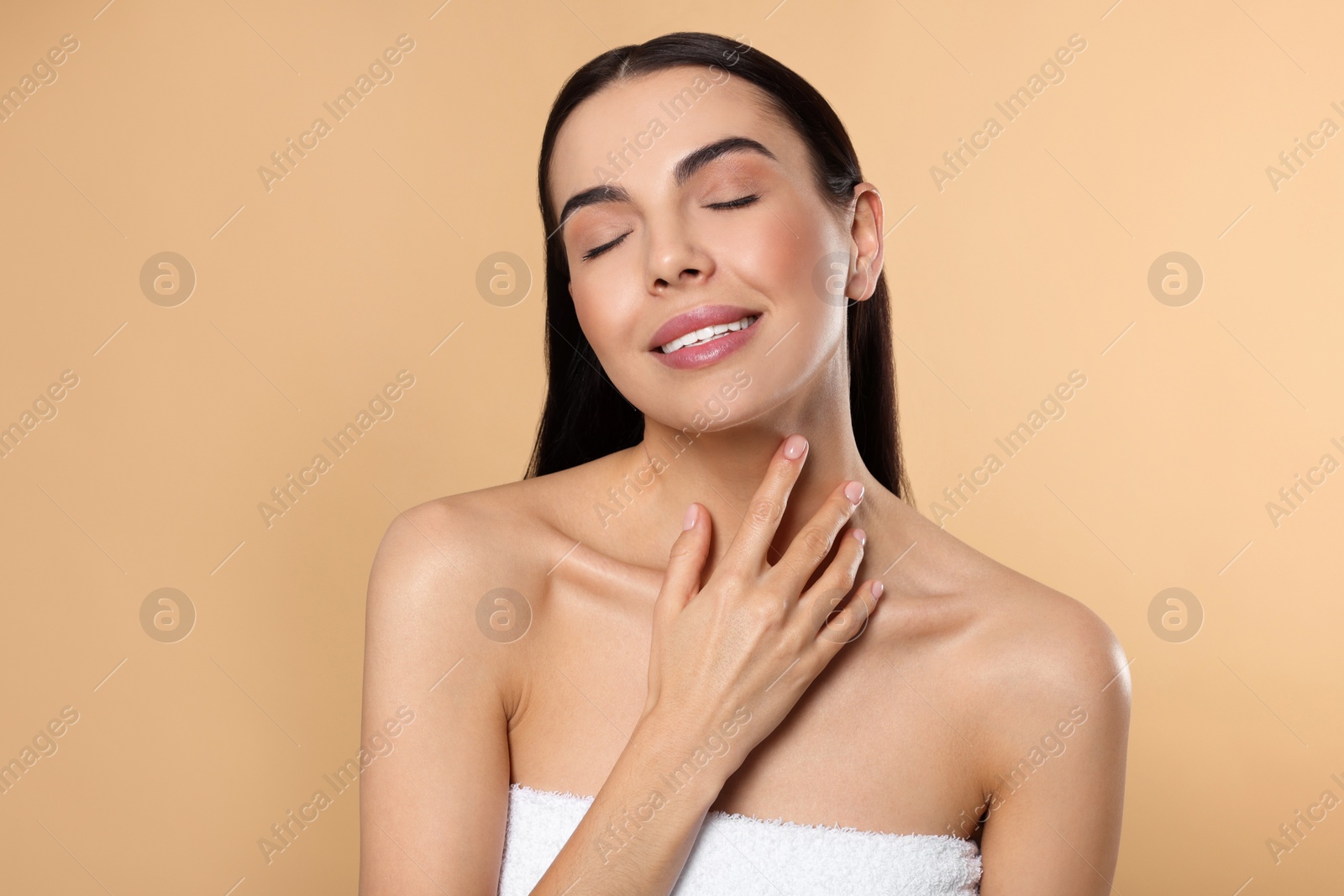 Photo of Portrait of attractive young woman on beige background. Spa treatment