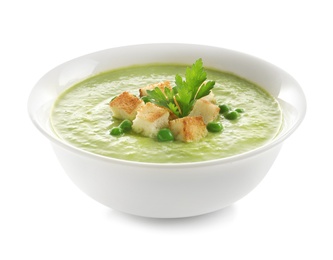 Photo of Fresh vegetable detox soup made of green peas with croutons in dish on white background