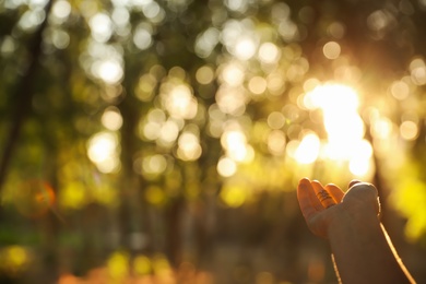 Young woman enjoying beautiful sunset, closeup view with space for text. Nature healing power