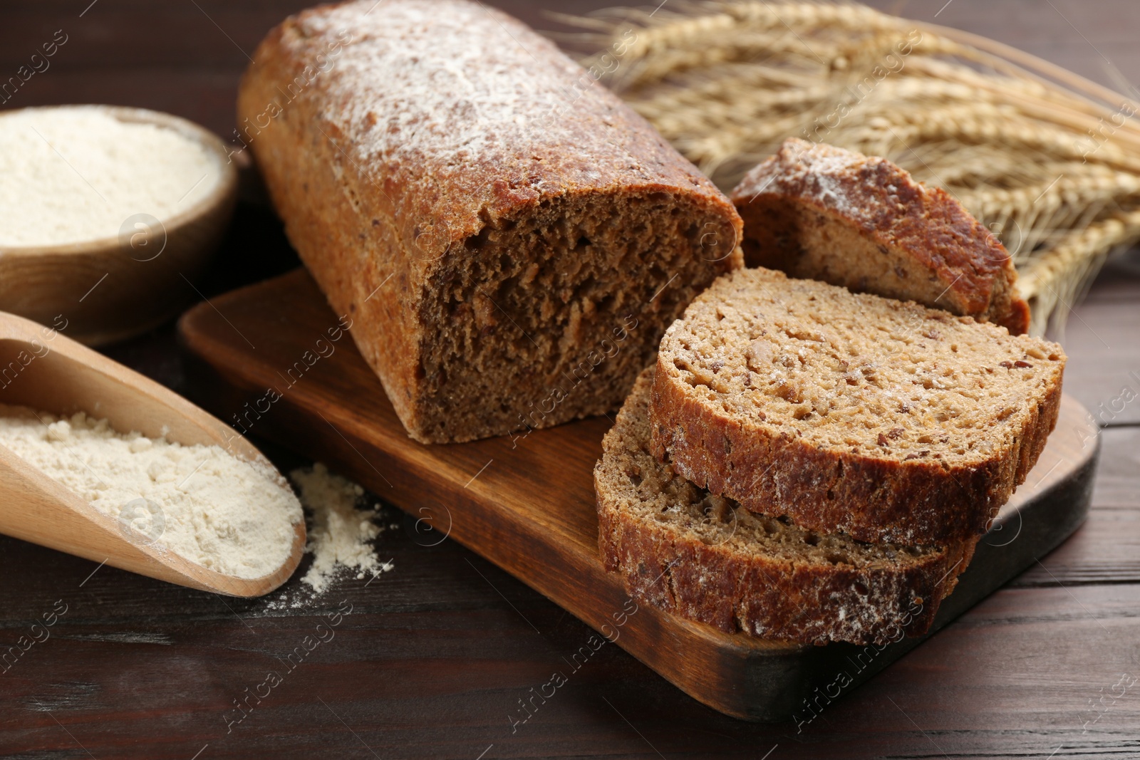 Photo of Tasty freshly baked bread on wooden table