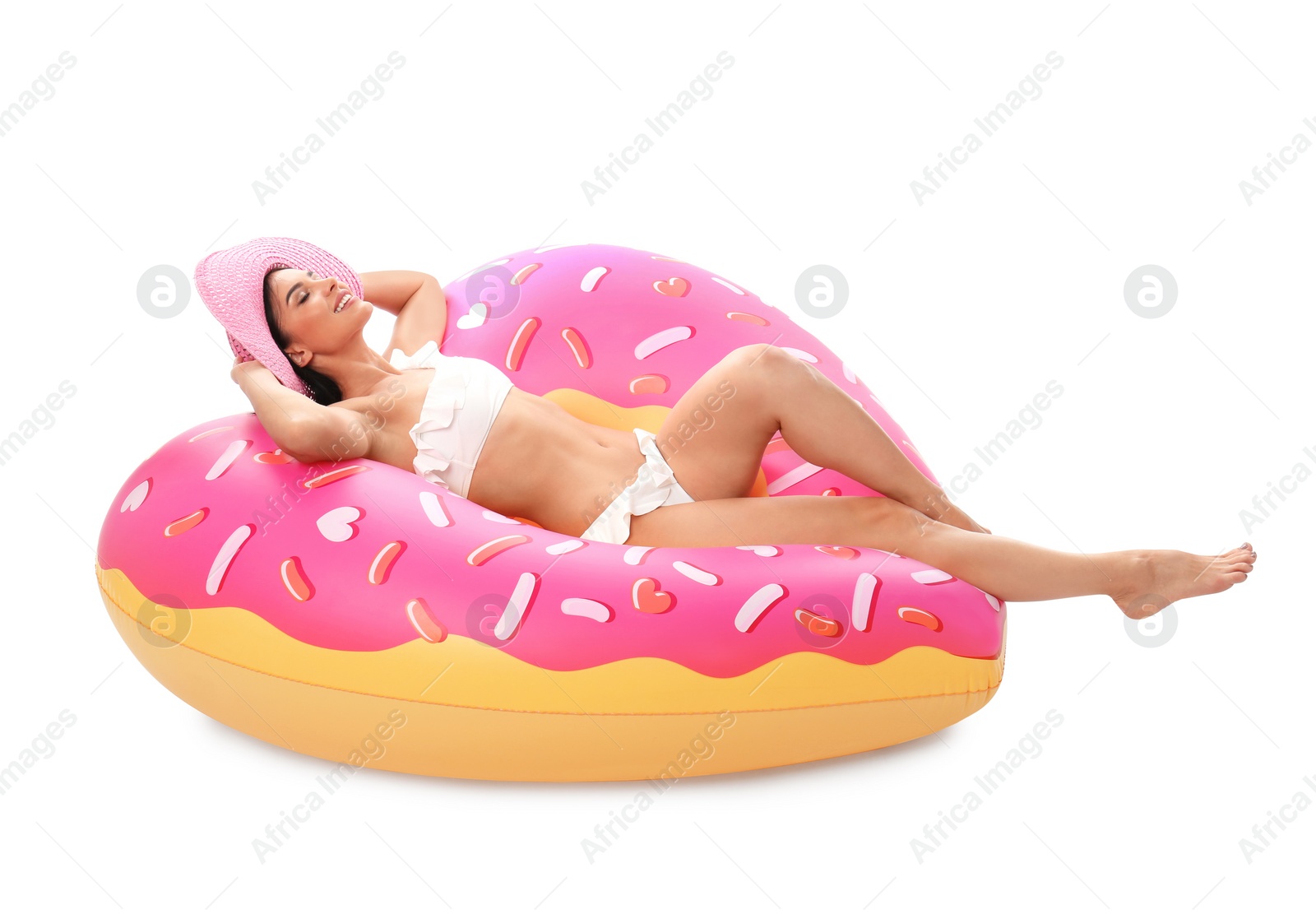 Photo of Beautiful young woman in stylish bikini with hat and inflatable ring on white background