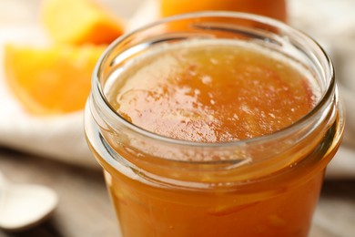 Homemade delicious orange jam on table, closeup view