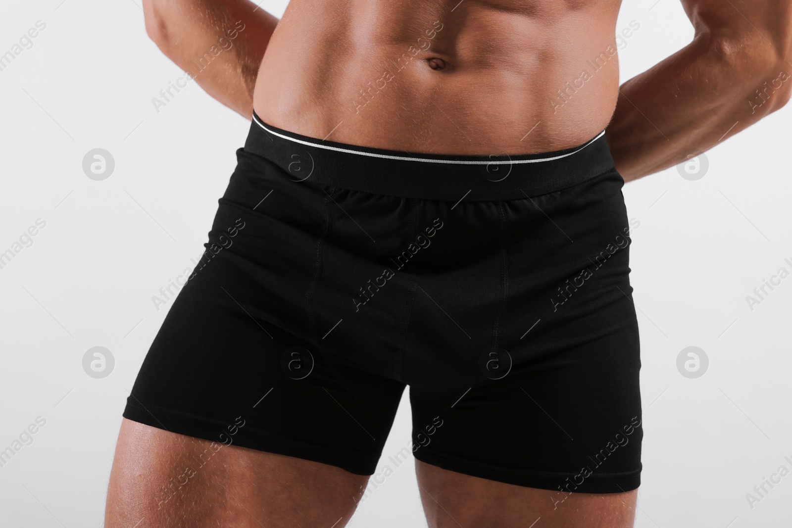 Photo of Young man is stylish black underwear on light grey background, closeup