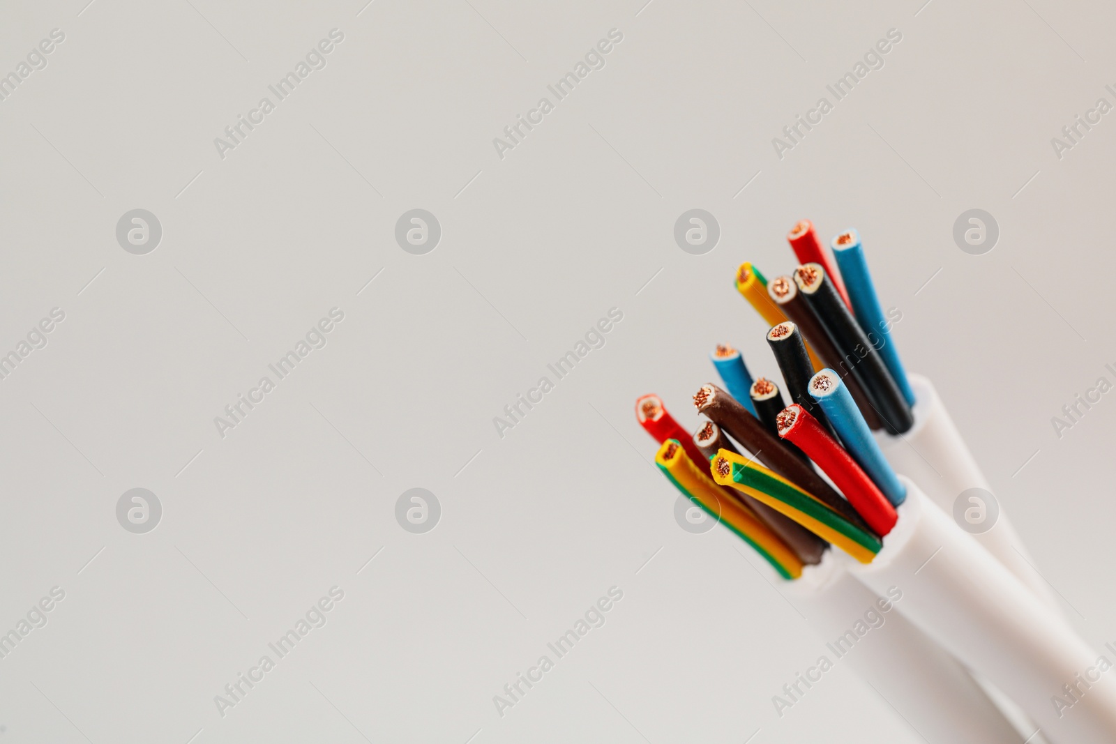 Photo of Cables with wires on light background, closeup. Space for text