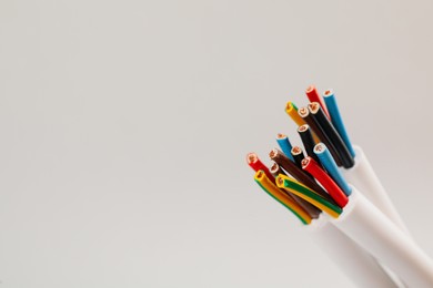 Cables with wires on light background, closeup. Space for text