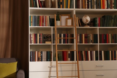 Photo of Home library interior with collection of different books on shelves