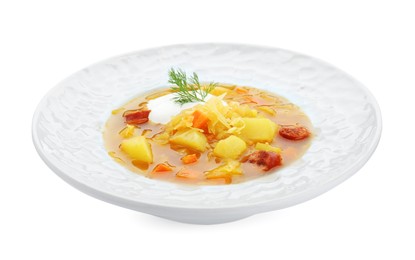 Delicious sauerkraut soup with smoked sausages dill and sour cream isolated on white