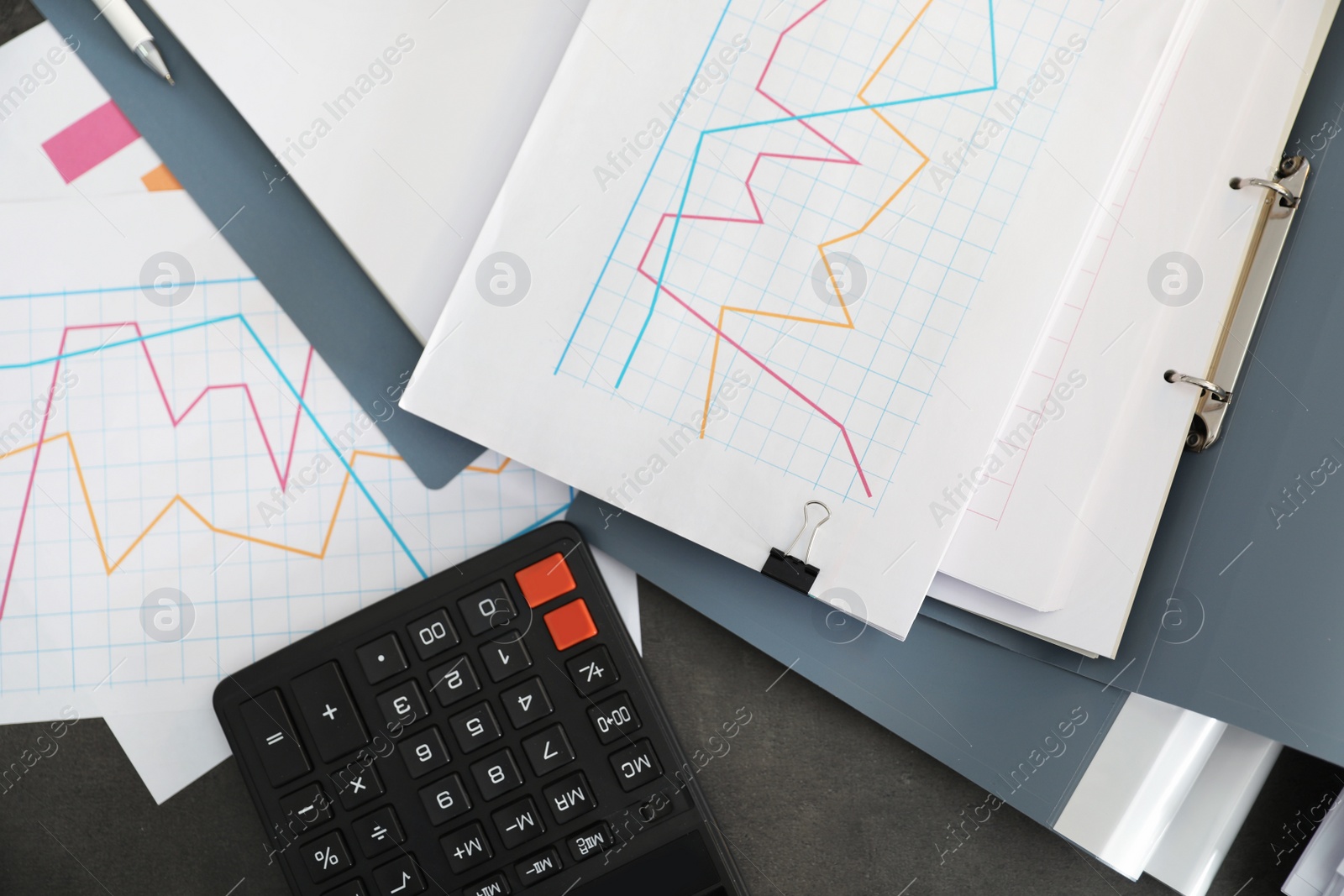 Photo of Folders with documents and calculator on office table, top view