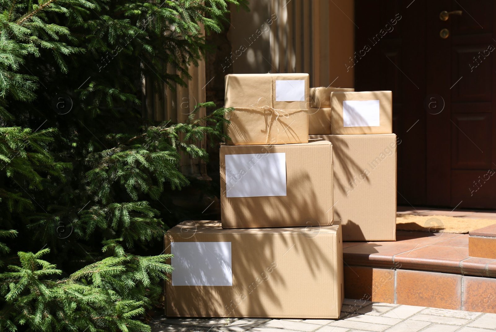 Photo of Delivered parcels on door mat near entrance